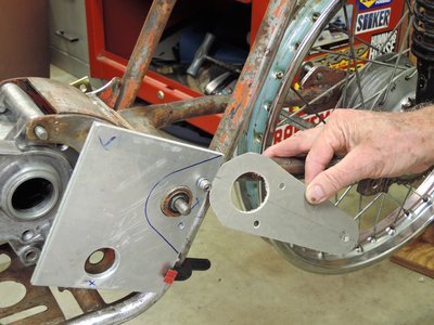 Both spacer and footpeg slip over swing arm boss.